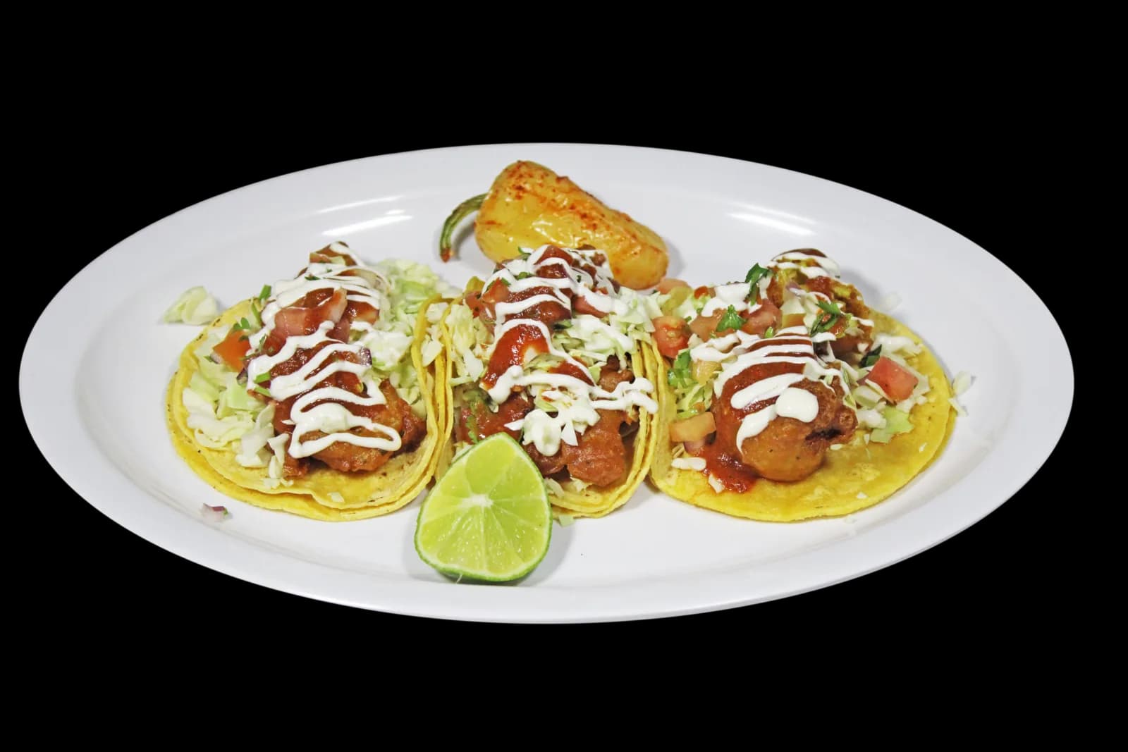 Fish tacos with cabbage, salsa and crema